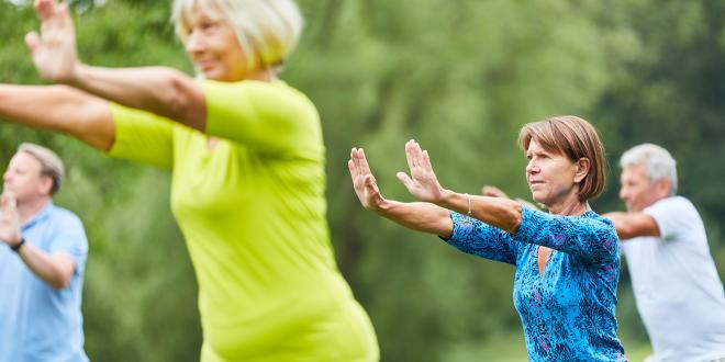 a group of senior men and women practicing t'ai chi