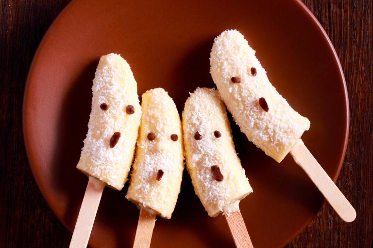 banana popsicles with coconut decorated for Halloween