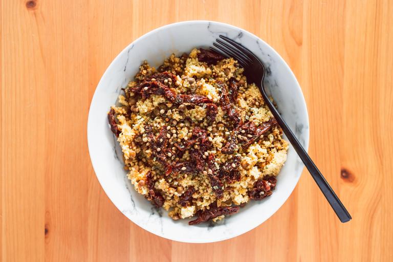 a bowl of couscous with lentils and veggies