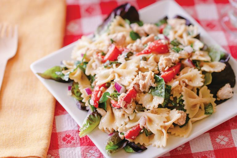 a plate of pasta with tuna and vegetables